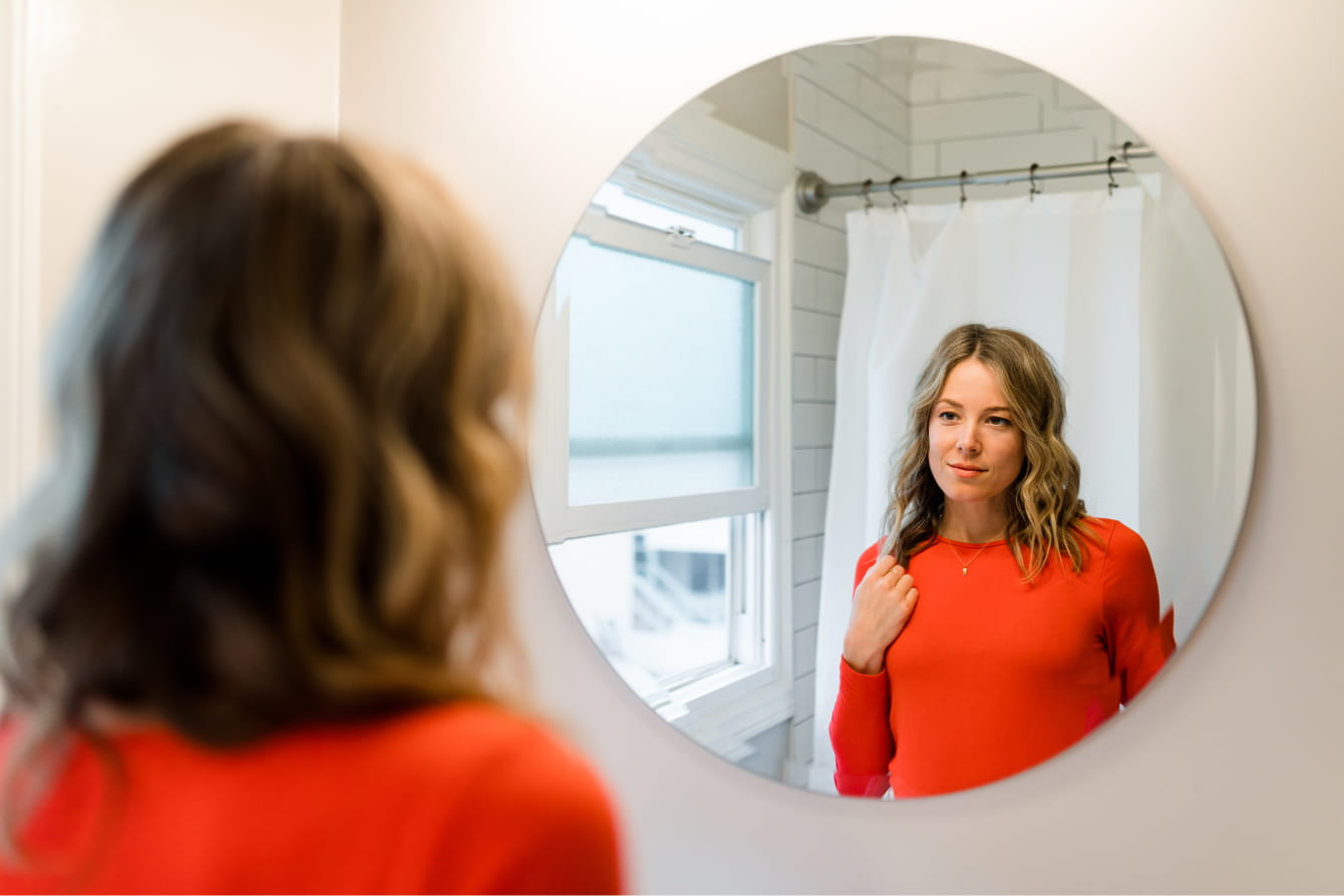 Woman looking at herself in a mirror