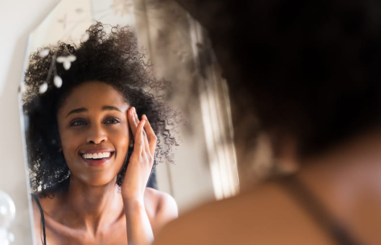 Woman looking at herself in a mirror